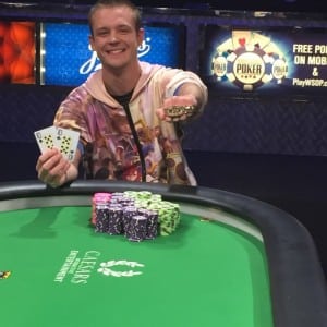 Adrian Buckley with the gold bracelet and winning hand