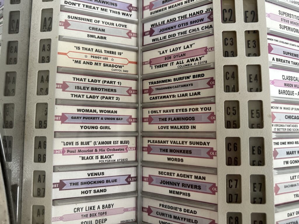 Close up of the title strips for the 45s inside the jukebox