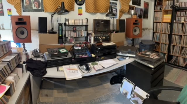 Bill Fitzhugh's radio studio with speakers, reel-to-reel deck, mixer, turntable and shelves of records