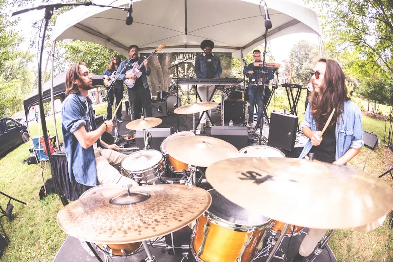DOOM GONG performing outdoors at a festival with two drum kits up front