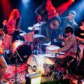 DOOM GONG performing live on stage under red and blue lights