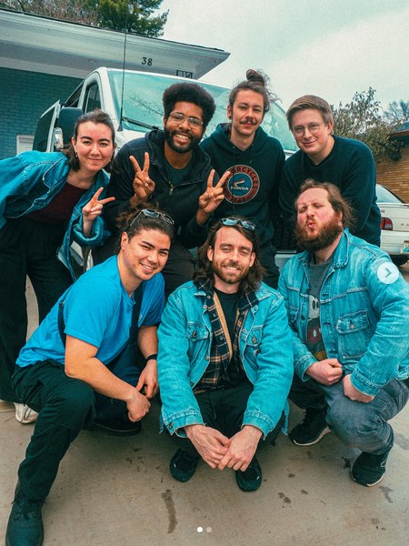 DOOM GONG band members posing together in front of their van